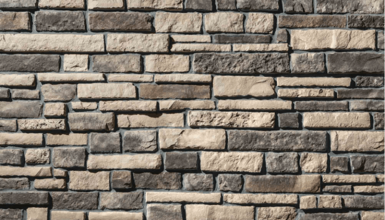 Close-up of dark gray chisel-cut manufactured stone veneer panels