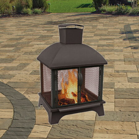 Bronze lantern-style wood-burning fire pit with mesh side panels on a stone patio