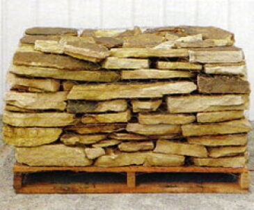 Pallet of flat gold and tan stone slabs, 1 to 3 inches thick, wire-banded.