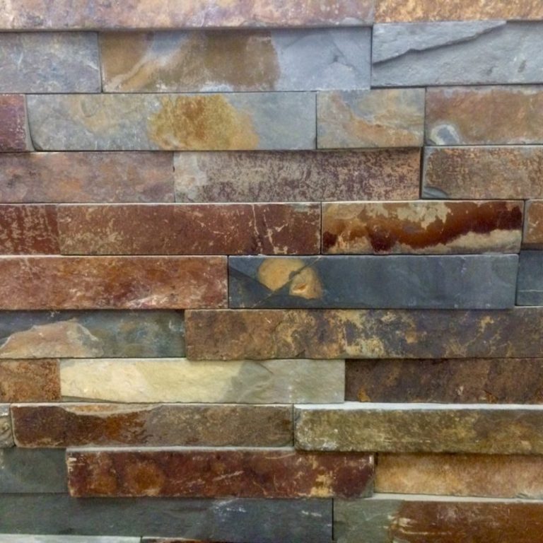 Close-up of stacked ledgestone veneer panel in rust, gold, and gray slate tones.