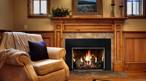 Wood-paneled fireplace mantel with a stone-tile surround around a gas fireplace insert