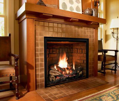 Large rectangular gas fireplace with tile surround and wood mantel in a living room