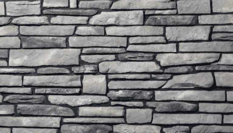 Manufactured ledgestone veneer panel sample in light and dark gray tones.