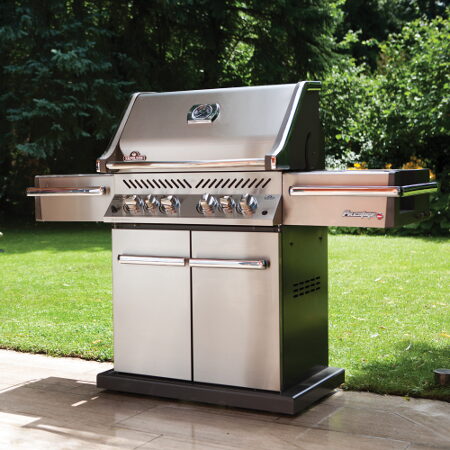 Stainless steel Napoleon gas grill with a side burner on a patio