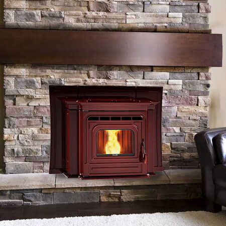 Dark red pellet stove insert set into a stacked stone fireplace with a wood mantel.