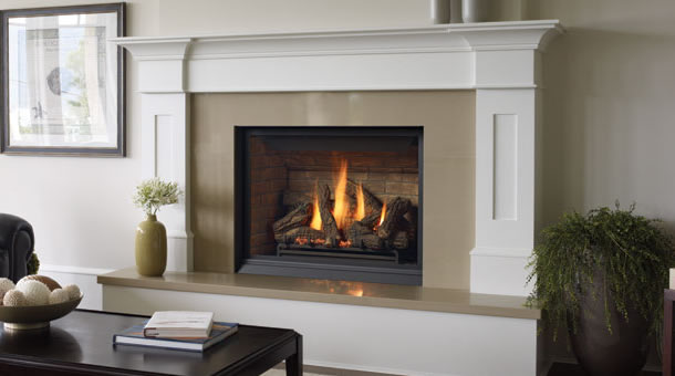 White mantel surround gas fireplace with glowing logs in a living room