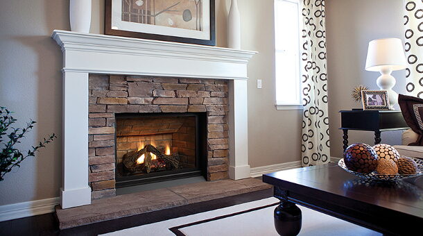 White mantel fireplace with a stacked-stone surround and a gas fireplace insert