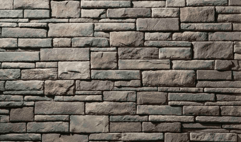 Manufactured dry-stack stone veneer panel sample in gray-brown tones.