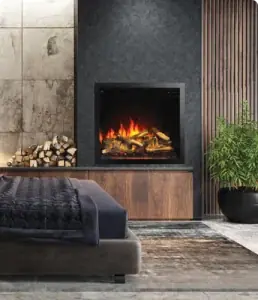 Black built-in fireplace insert framed by stacked firewood in a bedroom wall with a walnut cabinet