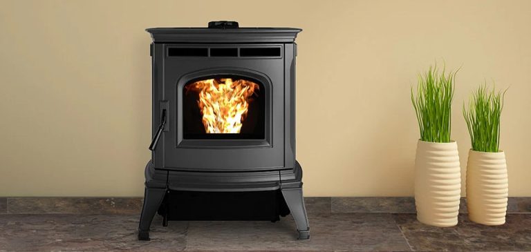 Black freestanding Harman pellet stove with top vents beside potted grasses