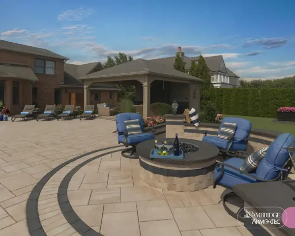 Paver patio with round fire pit, blue cushioned lounge chairs, and a large home in the background